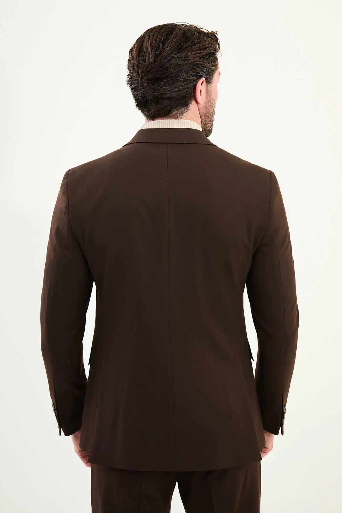 Men wearing chocolate brown slim-fit double-breasted wool-blend suit with peak lapels and cream turtleneck, winter formal outfit.