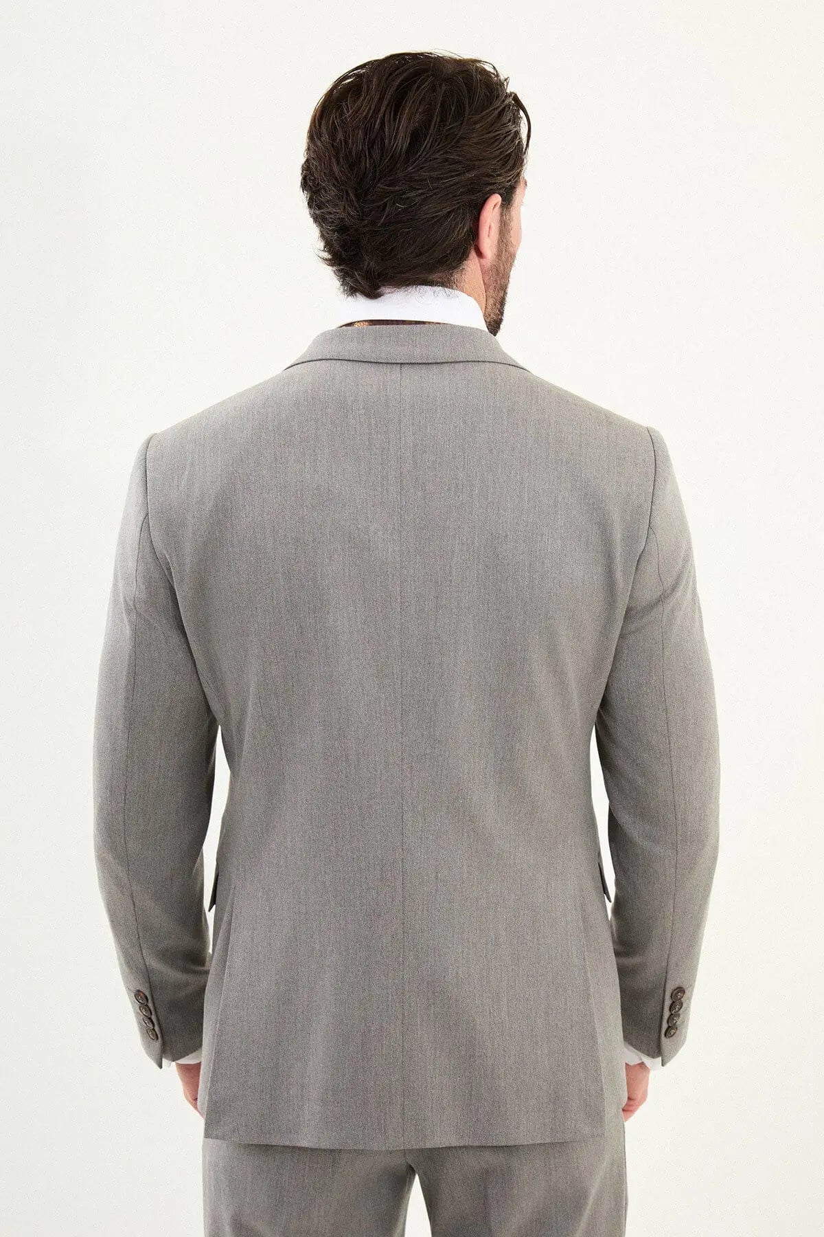 Men’s light gray slim-fit three-piece wool-blend winter suit with single-breasted jacket, notch lapels, matching waistcoat, dark buttons, and black origami lapel pin.