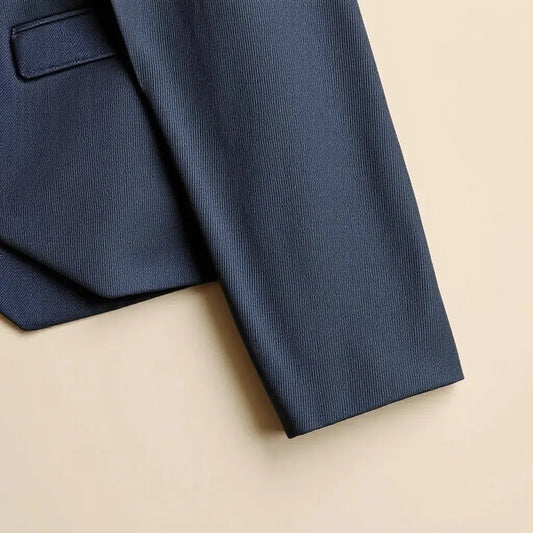 Tailored suit fabric swatch and jacket sleeve detail showing fine weave and drape