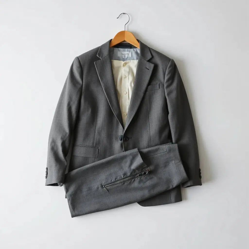 Slim-fit suit jacket and trousers neatly arranged on a hanger with crisp fabric texture