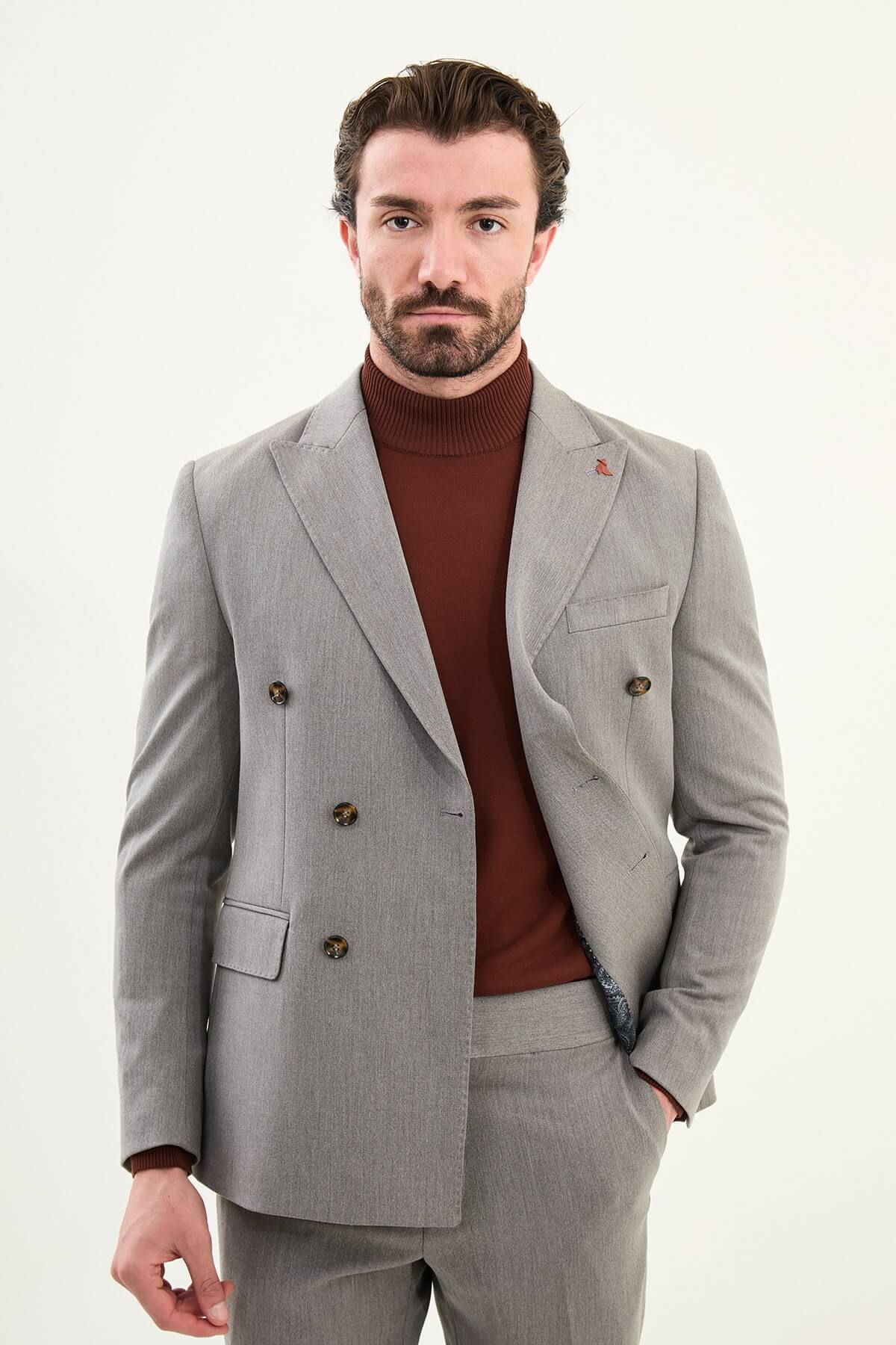 Men’s heather gray slim-fit double-breasted wool-blend suit with wide peak lapels, barchetta chest pocket, tortoiseshell buttons, and red origami lapel pin.