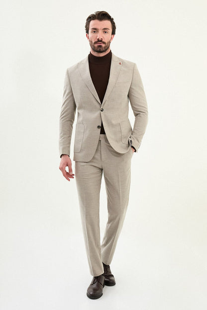 Men’s beige slim-fit mono-collar (mandarin collar) winter suit with minimalist single-breasted jacket, matte micro-texture active-recovery fabric, styled with a dark brown turtleneck.