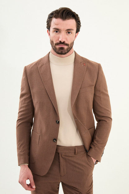 Men’s camel slim-fit mono-collar suit with pointed minimalist collar, matte micro-texture fabric, single-breasted jacket, and styled with a cream turtleneck for tonal winter dressing.
