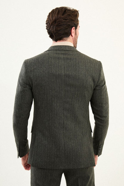 Men’s olive-toned khaki herringbone slim-fit single-breasted suit with structured shoulders and tailored waist, high-wool blend fabric with stretch for winter wear, styled with a cream fine-gauge turtleneck.