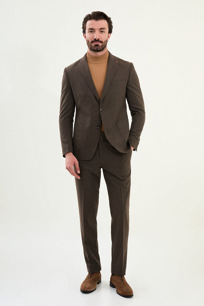 Men’s light brown slim-fit mono-collar (mandarin collar) winter suit with minimalist single-breasted jacket, matte micro-texture active-recovery fabric, styled with a camel turtleneck for tonal dressing.