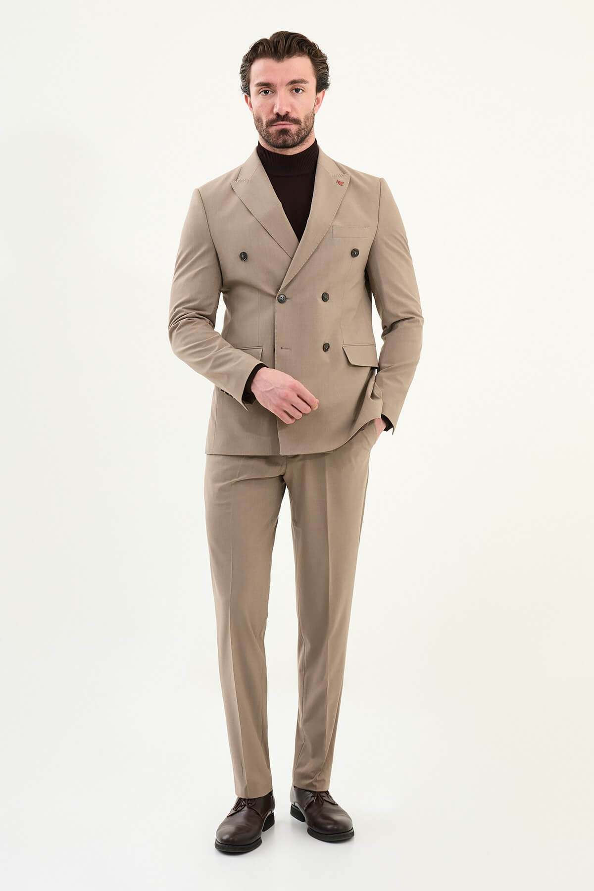 Men’s light brown sandstone slim-fit double-breasted 6x2 suit with peak lapels, cotton-wool-viscose blend with 4-way stretch for wrinkle-resistant wear, styled with a tonal brown turtleneck.