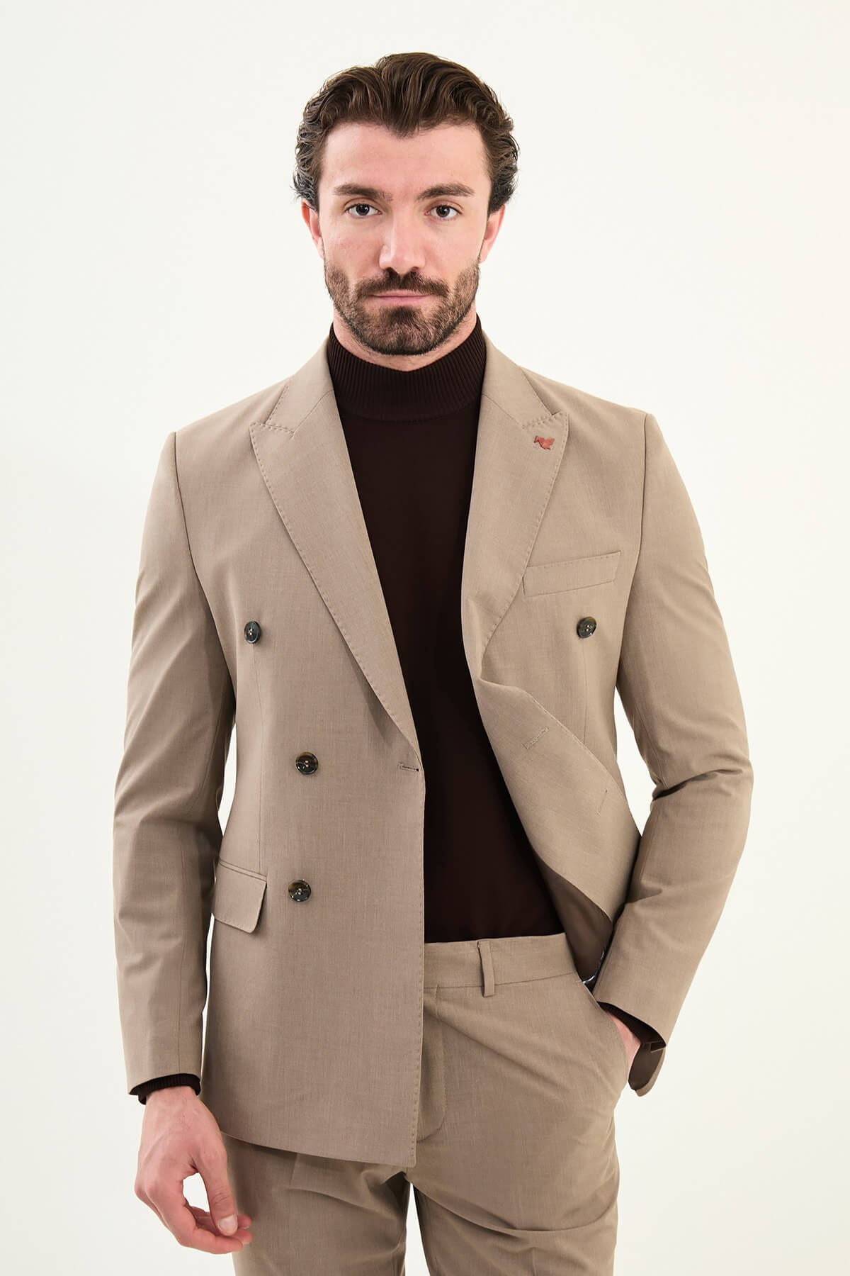 Men’s light brown sandstone slim-fit double-breasted 6x2 suit with peak lapels, cotton-wool-viscose blend with 4-way stretch for wrinkle-resistant wear, styled with a tonal brown turtleneck.