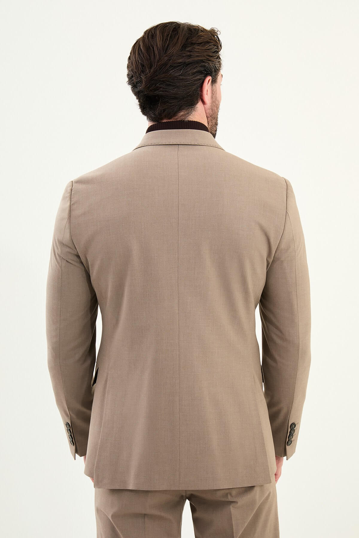 Men’s light brown sandstone slim-fit double-breasted 6x2 suit with peak lapels, cotton-wool-viscose blend with 4-way stretch for wrinkle-resistant wear, styled with a tonal brown turtleneck.